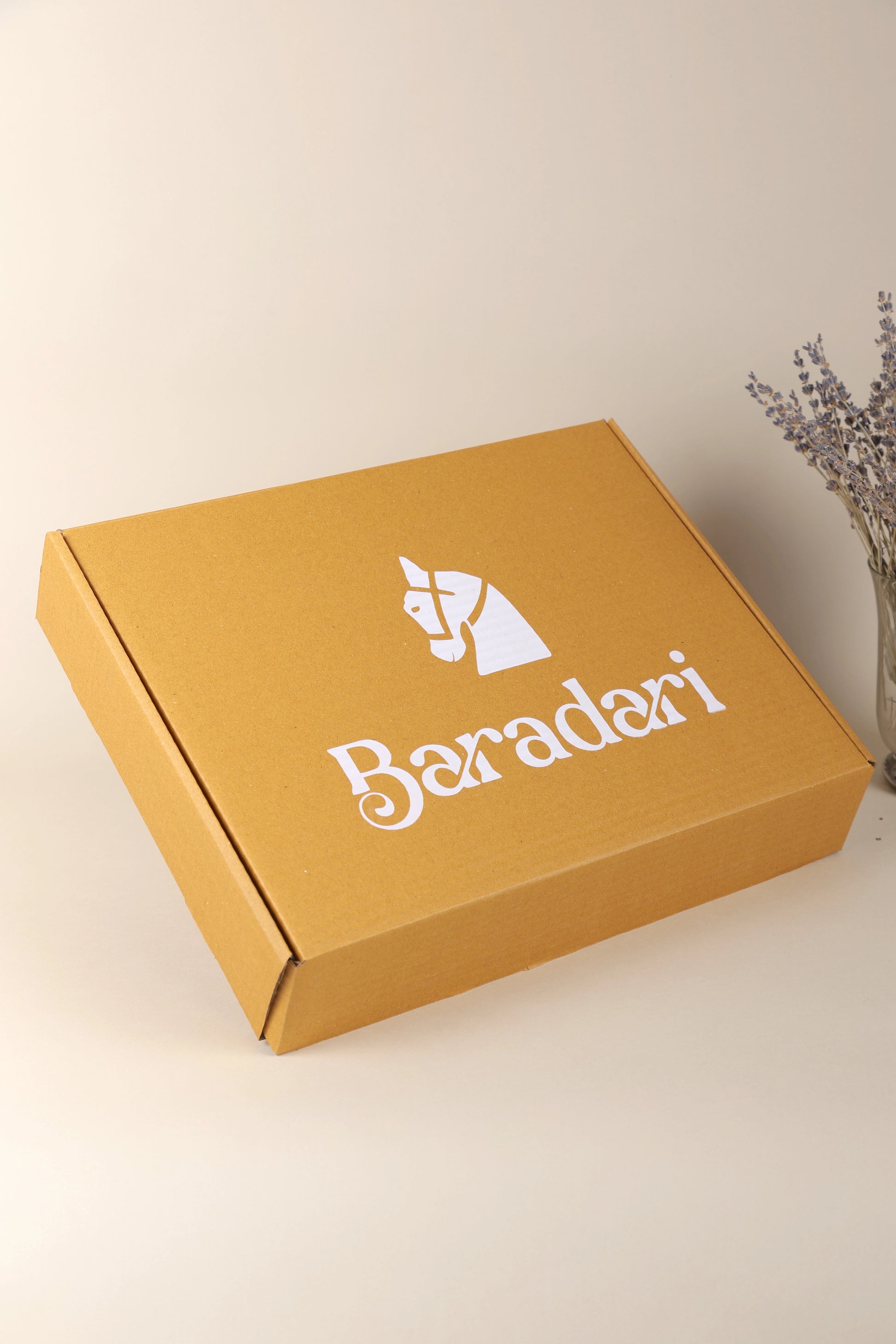 "Baradari luxury gift box in mustard yellow with baradari logo — premium corporate gifting and festive hamper packaging by Baradari"