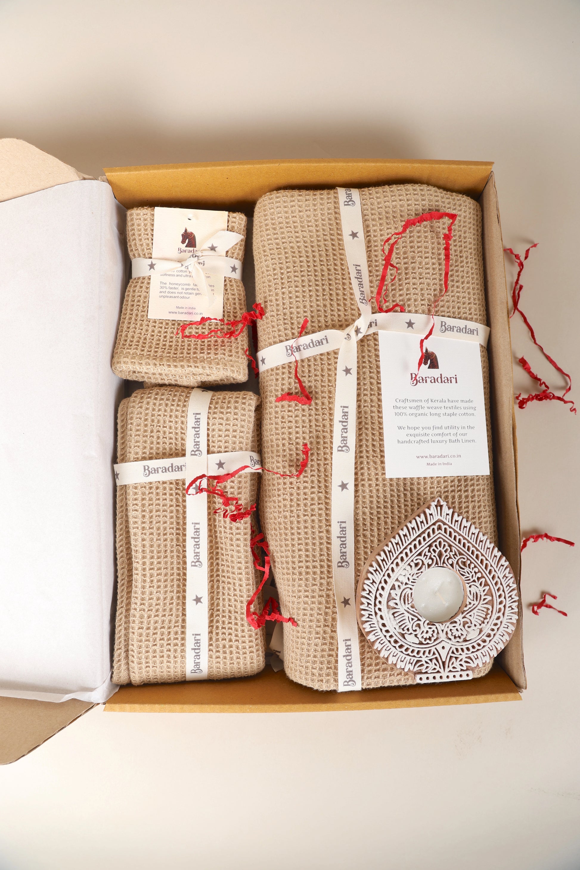 "Baradari luxury bath linen gift set with natural beige waffle weave bath towel, hand towels, and handcrafted diya — premium gifting hamper by Baradari"
